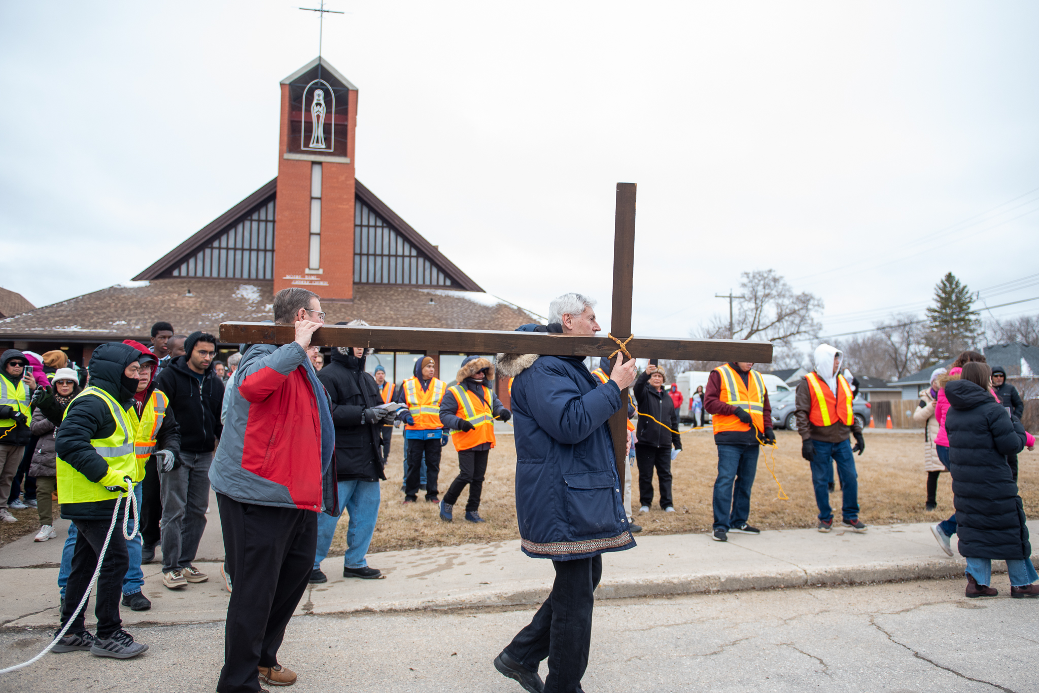 Community members carrying a cross in a Good Friday Walk of Witness